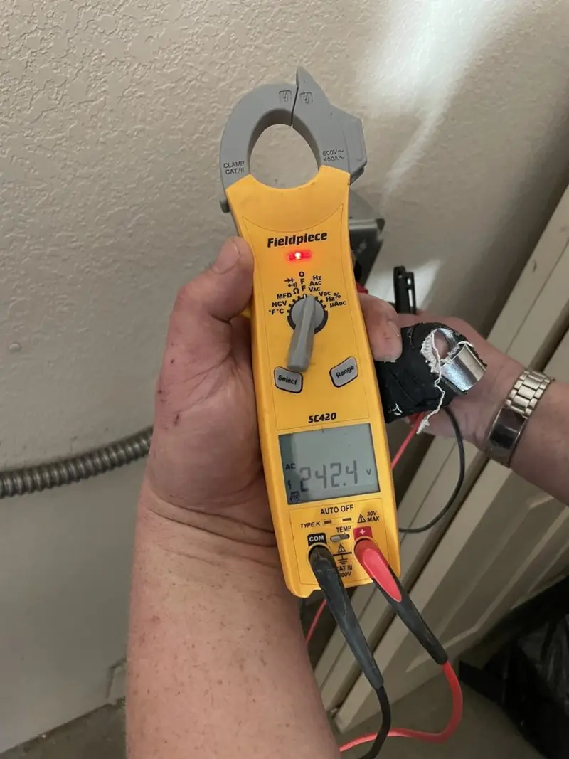 Voltage testing with clamp meter during Electrical Installation Services in Underwood-Petersville